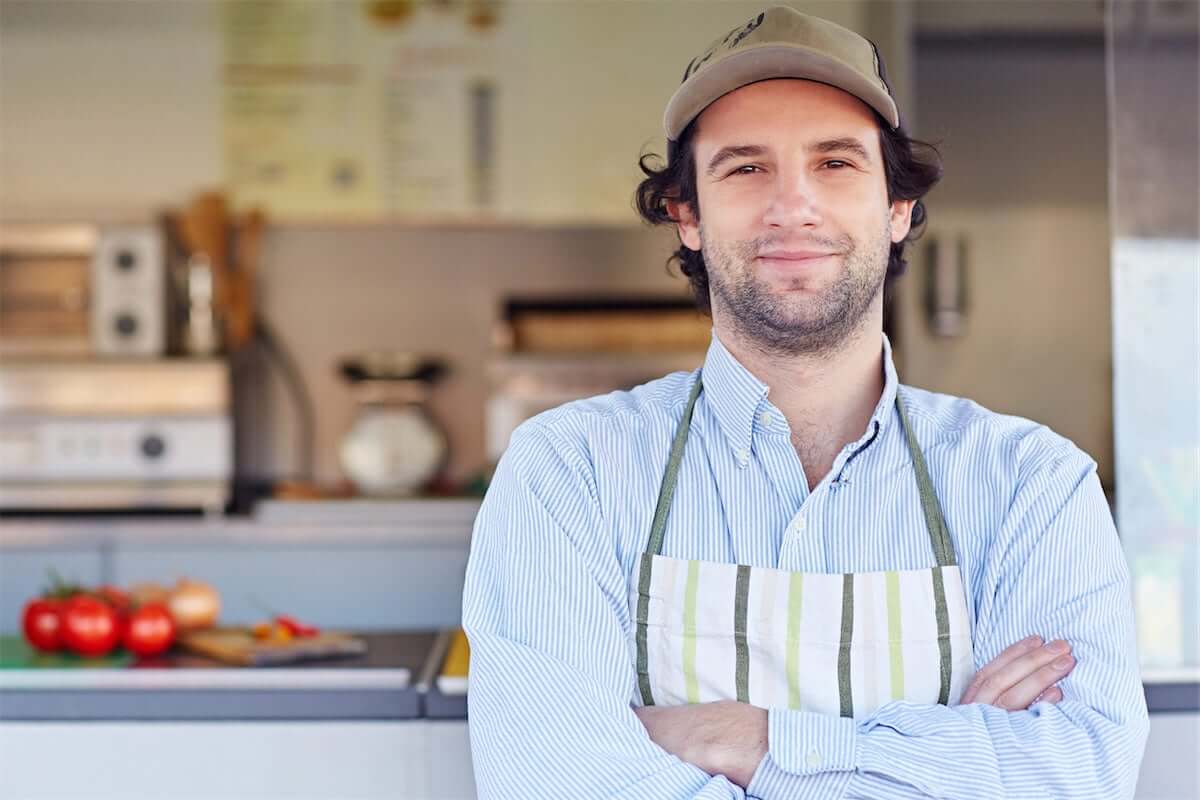 Business owner in front of takeaway food